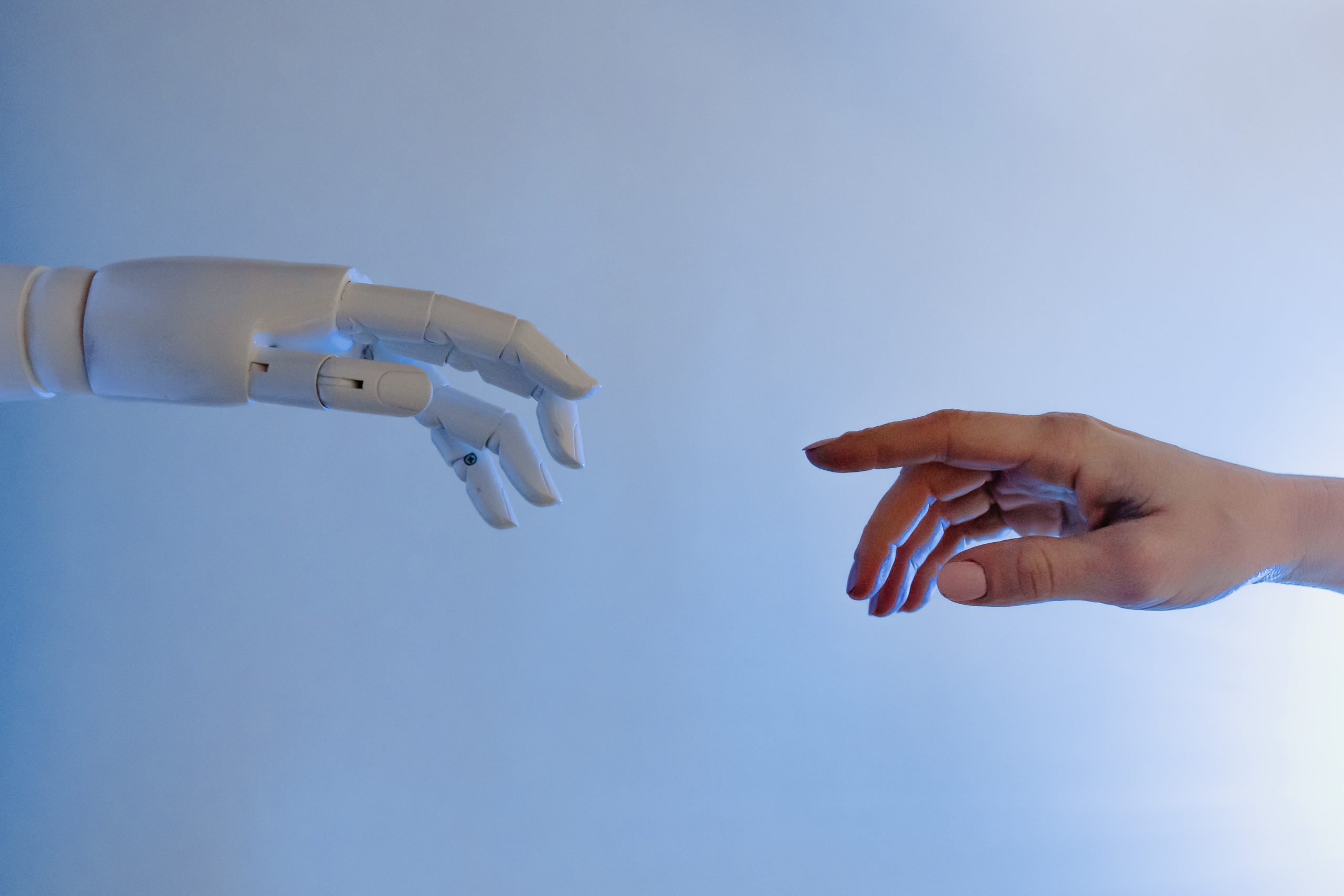 A picture of a human hand and a robot hand reaching out to each other like Michelangelo's "The Creation of Adam", artificial intelligence is available to channel partners but why isn't AI catching on?