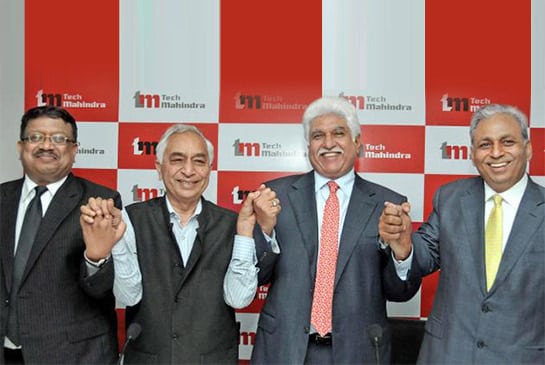 Company leaders hold hands after the official merger of Satyam and TechM in 2013.