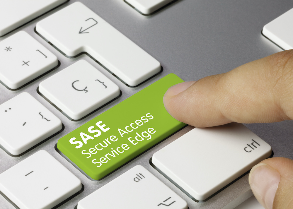 SASE Secure Access Service Edge Written on Green Key of Metallic Keyboard.